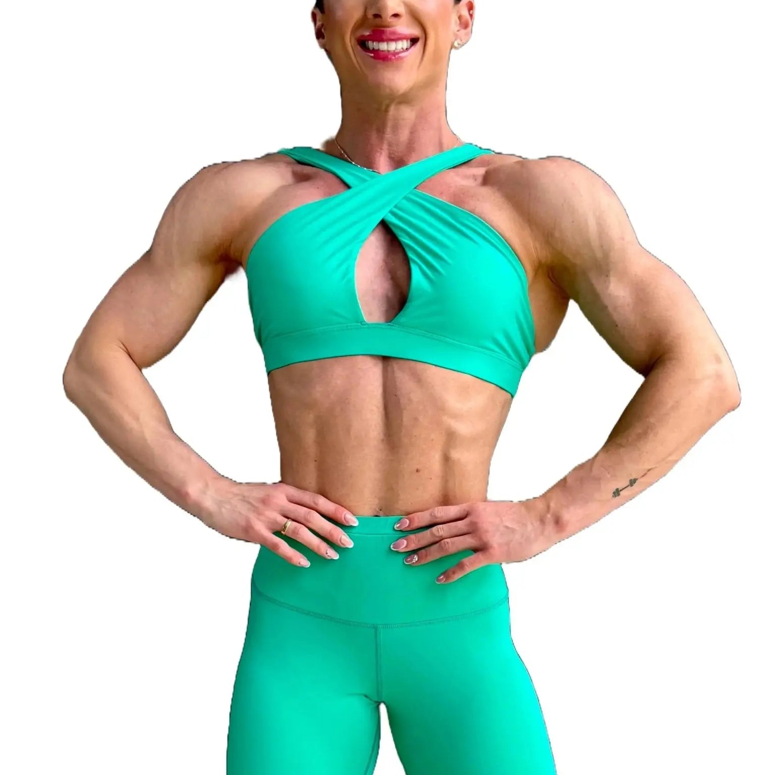 Modelo luciendo el conjunto verde de Top Paula y Legging Myself, mostrando el top con su diseño de tirantes cruzados para mayor sujeción.ción.