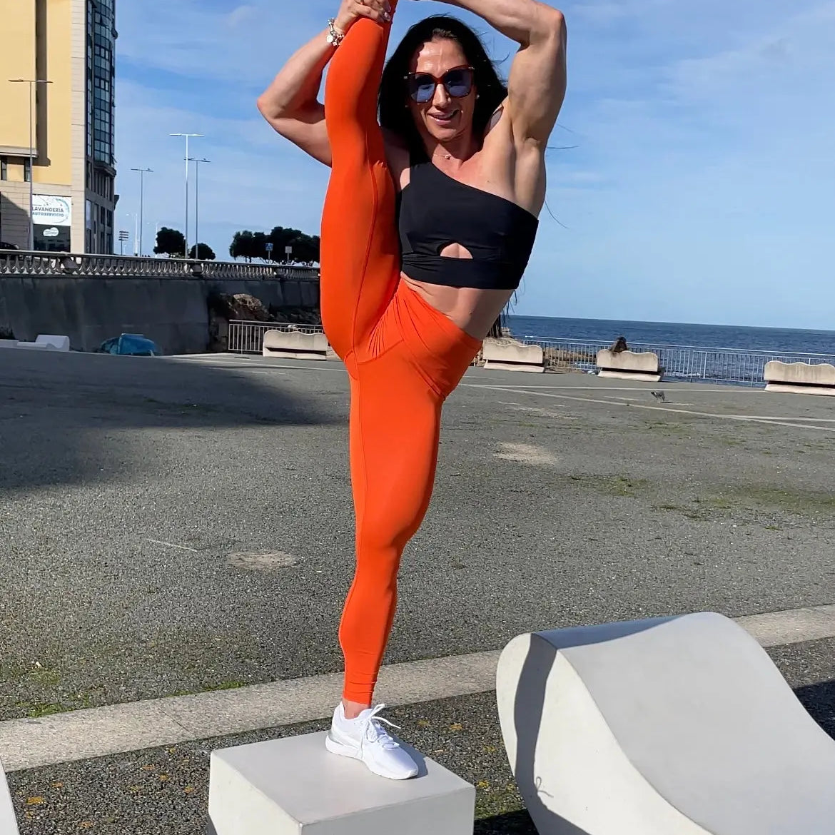 Mujer vistiendo los leggings compresivos de cintura alta Legging Myself de LUXFEEL en color Naranja, que ofrecen un efecto segunda piel.
