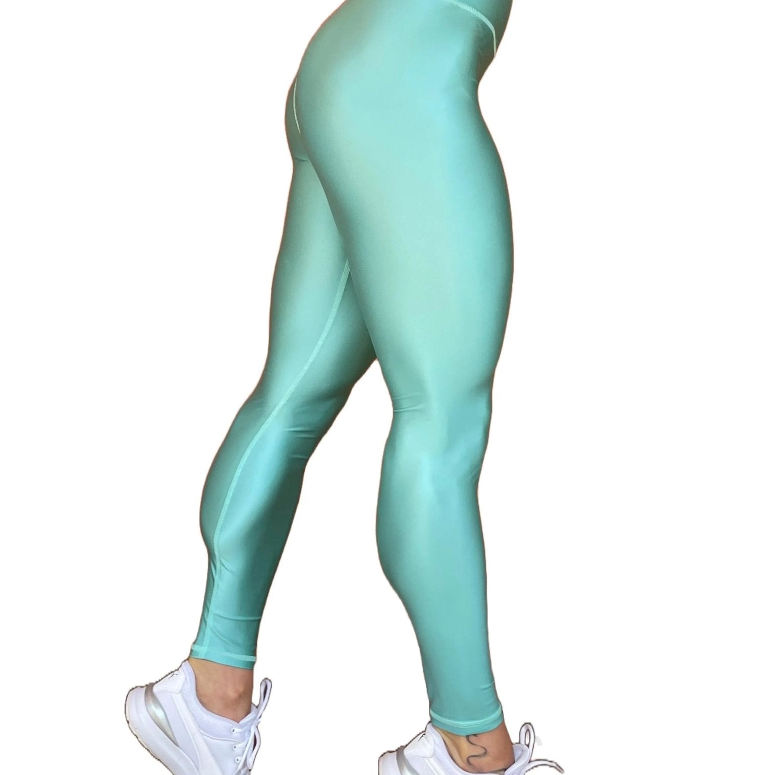 Mujer vistiendo los leggings brillantes de cintura alta Legging Pearl Shine de LUXFEEL en color Azul Celeste Brillante, con acabado efecto perla.