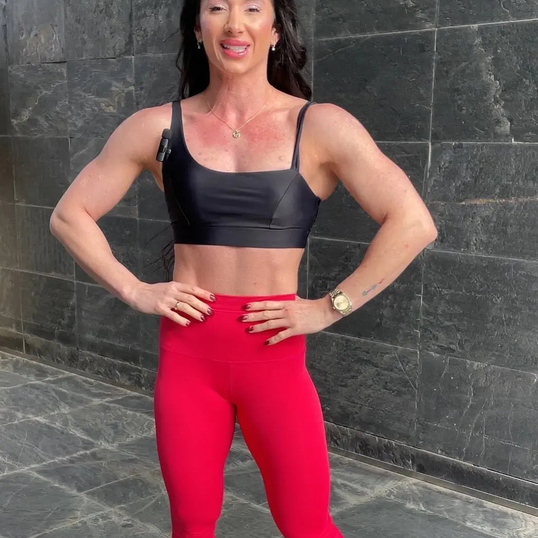 Mujer vistiendo el top deportivo Top Valentina de LUXFEEL en color Negro, con un romántico escote en forma de corazón.