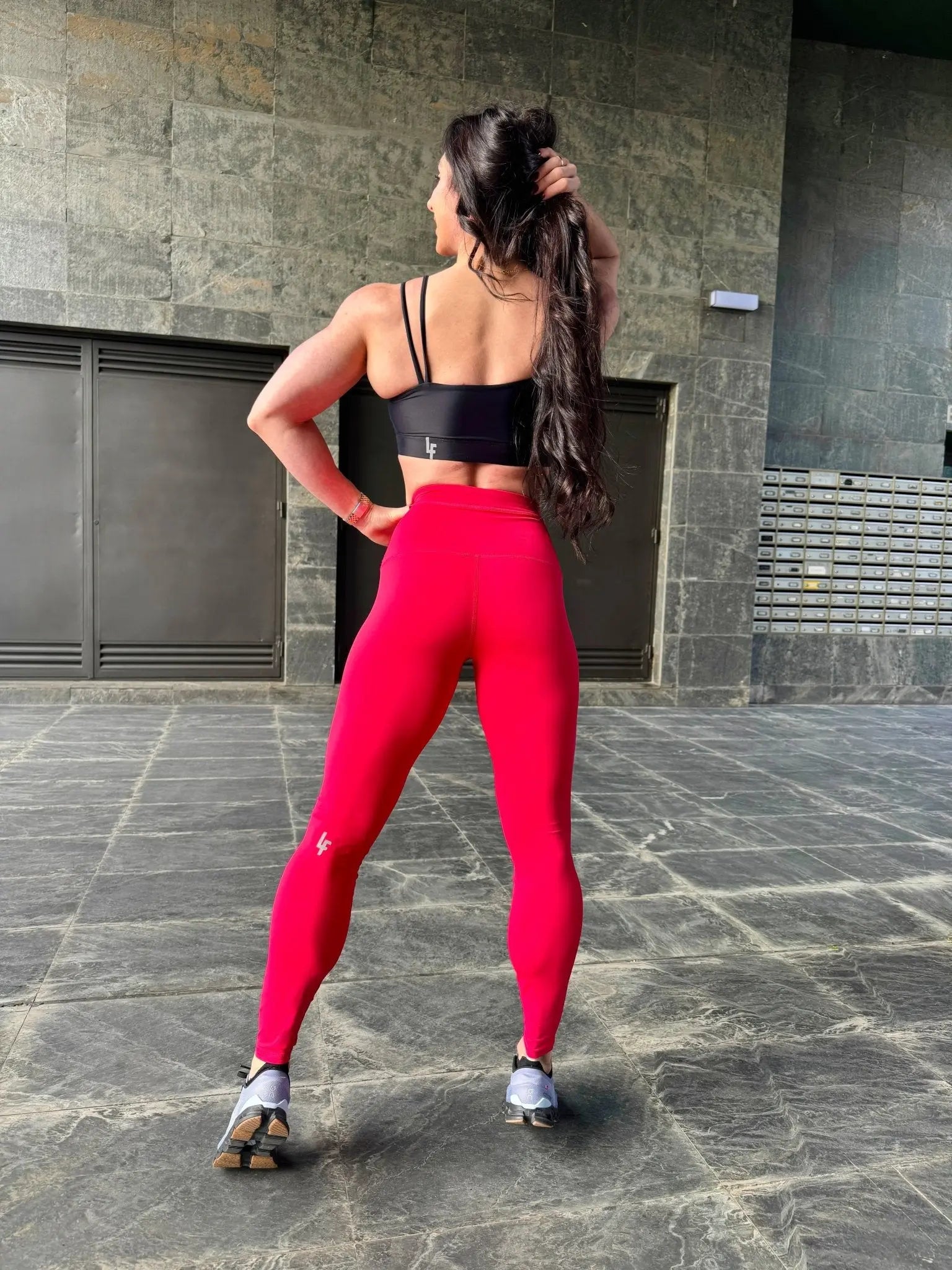 Mujer vistiendo el top deportivo Top Valentina de LUXFEEL en color Negro, con un romántico escote en forma de corazón.
