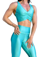 Mujer vistiendo el conjunto deportivo azul celeste de LUXFEEL, compuesto por el crop top brillante Adela Pearl Shine y el legging escultor Myself.