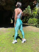 Mujer vistiendo los leggings brillantes de cintura alta Legging Pearl Shine de LUXFEEL en color Azul Celeste Brillante, con acabado efecto perla.